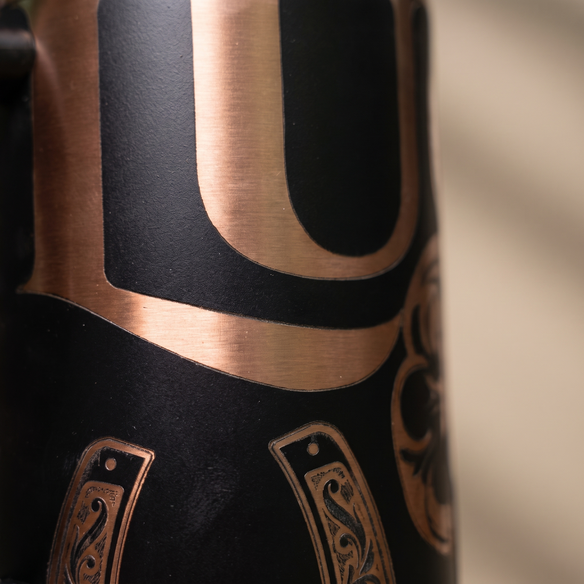 40oz Lucky Shamrock tumbler - close-up of laser engraved four-leaf clover and checkerboard detail