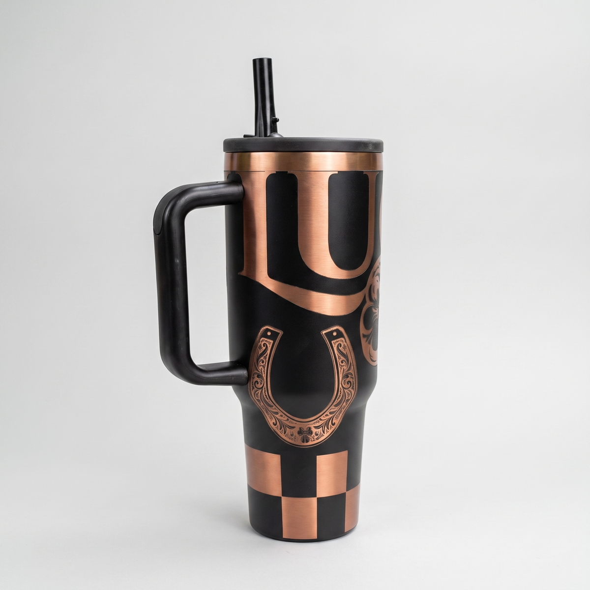40oz Lucky Shamrock tumbler - laser engraved Lucky text with four-leaf clover and horseshoe on black and copper tumbler, studio hero shot