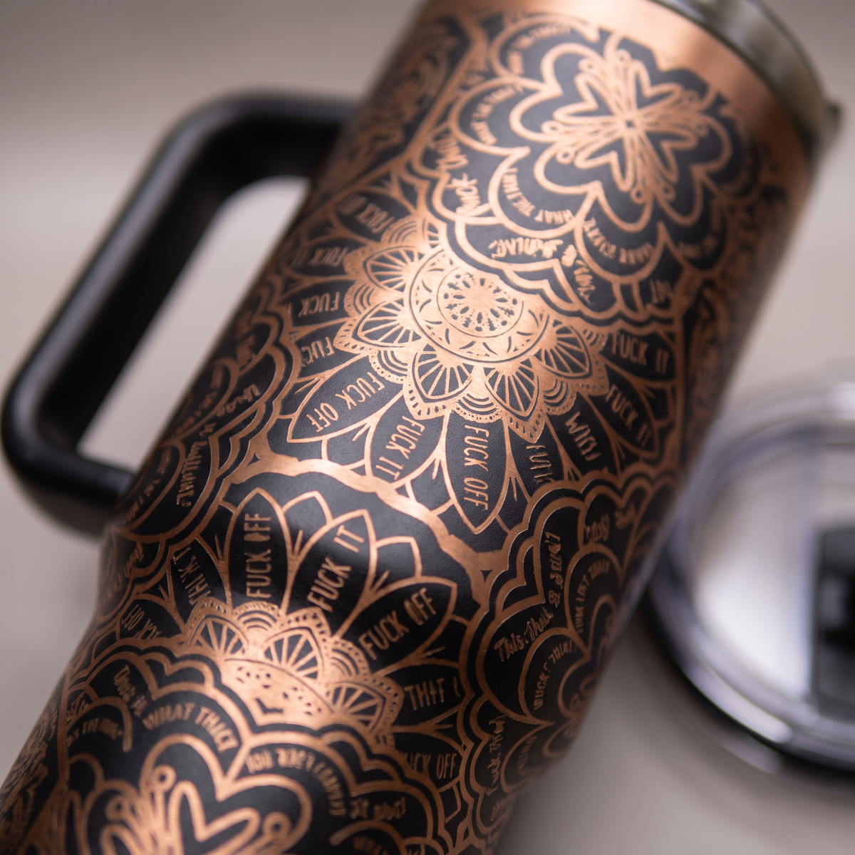 Laser engraved mandala pattern 40oz tumbler with bold lettering - studio macro shot
