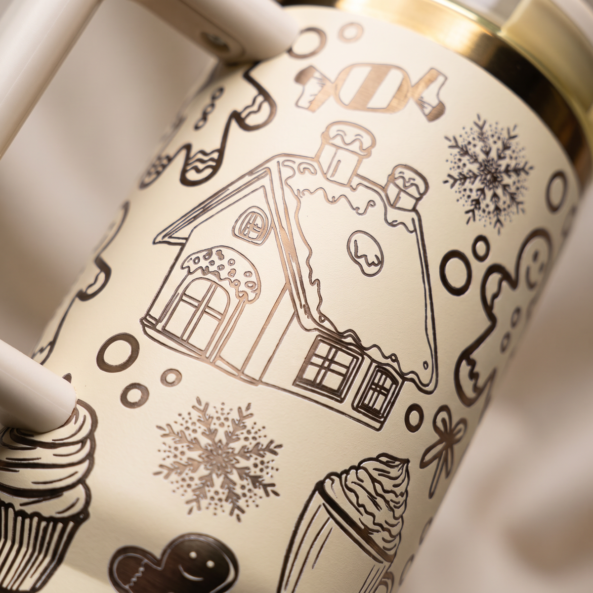 40oz Gingerbread tumbler - close-up of laser engraved gingerbread house and snowflakes