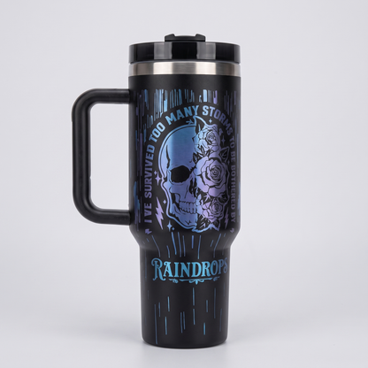40oz Survived Storms tumbler - laser engraved half-skull half-floral design, studio hero shot