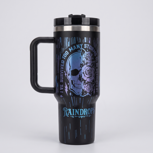 40oz Survived Storms tumbler - laser engraved half-skull half-floral design, studio hero shot