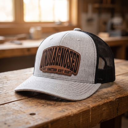 Undiagnosed But Somethin Aint Right Trucker Hat - Heather Grey/Black
